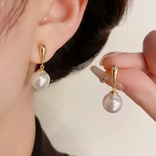 Pearl & 18K Gold | These (light luxury) textured gold-clasp pearl earrings are the epitome of elegance once worn.