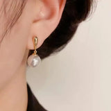 Pearl & 18K Gold | These (light luxury) textured gold-clasp pearl earrings are the epitome of elegance once worn.